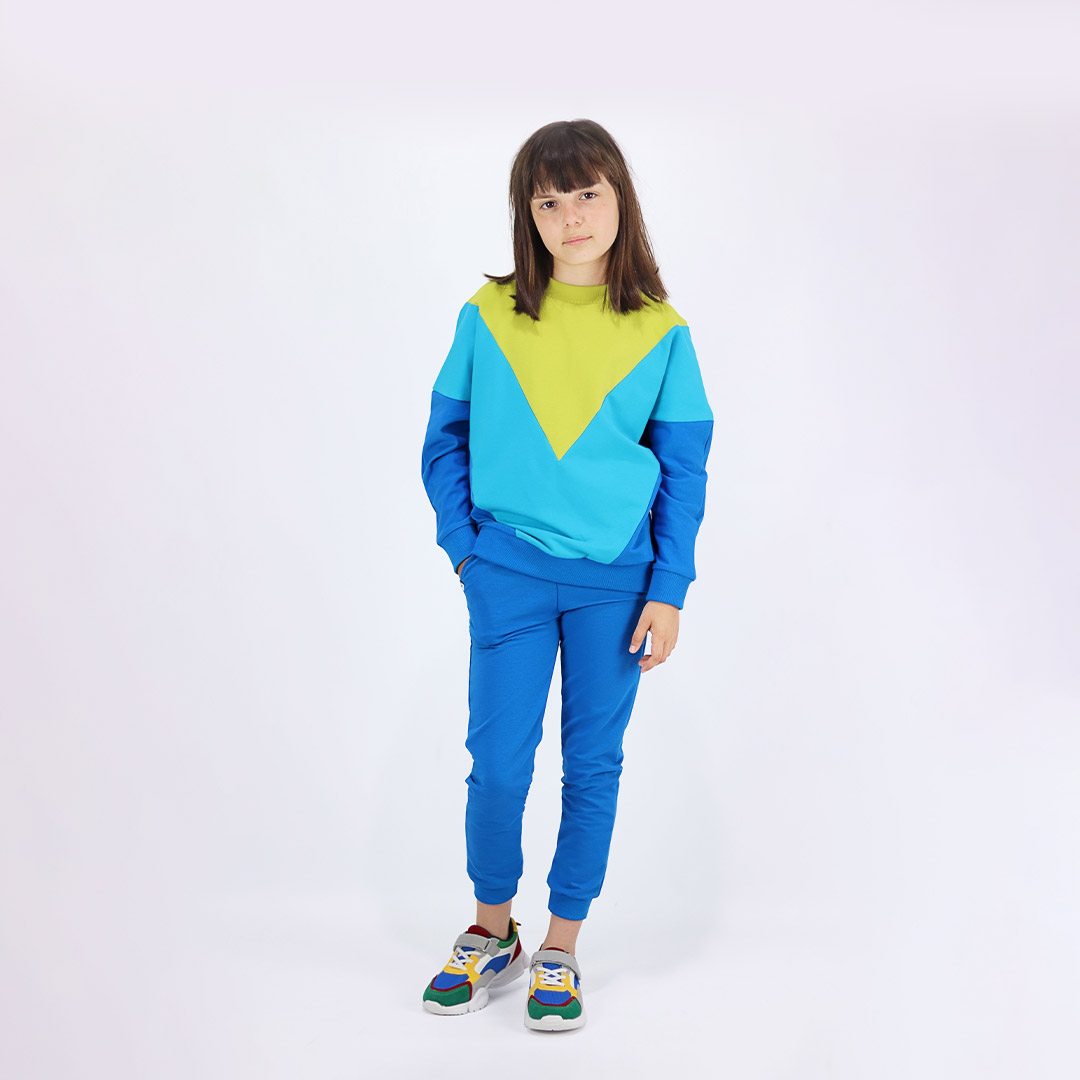 Batwing sweatshirt is a loose fit top with triangular form color blocks. It comes in a combo of three colours - bright lime, electric blue and deep blue. Front view. Children, 3 -10 yrs. BonnyJoy