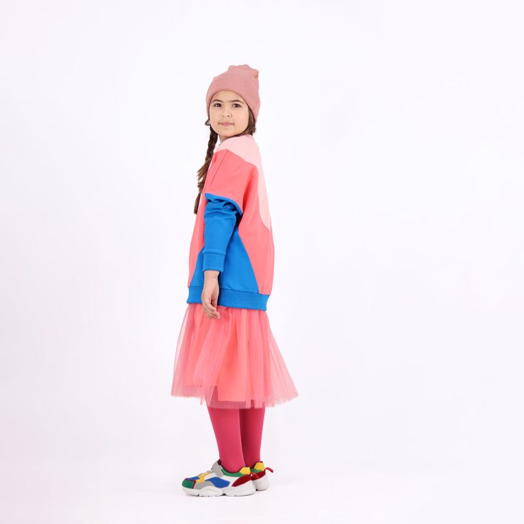 Batwing sweatshirt is a loose fit top with triangular form color blocks. It comes in a combo of three colours - powder, salmon and deep blue. Left view. Children, 3 -10 yrs. BonnyJoy