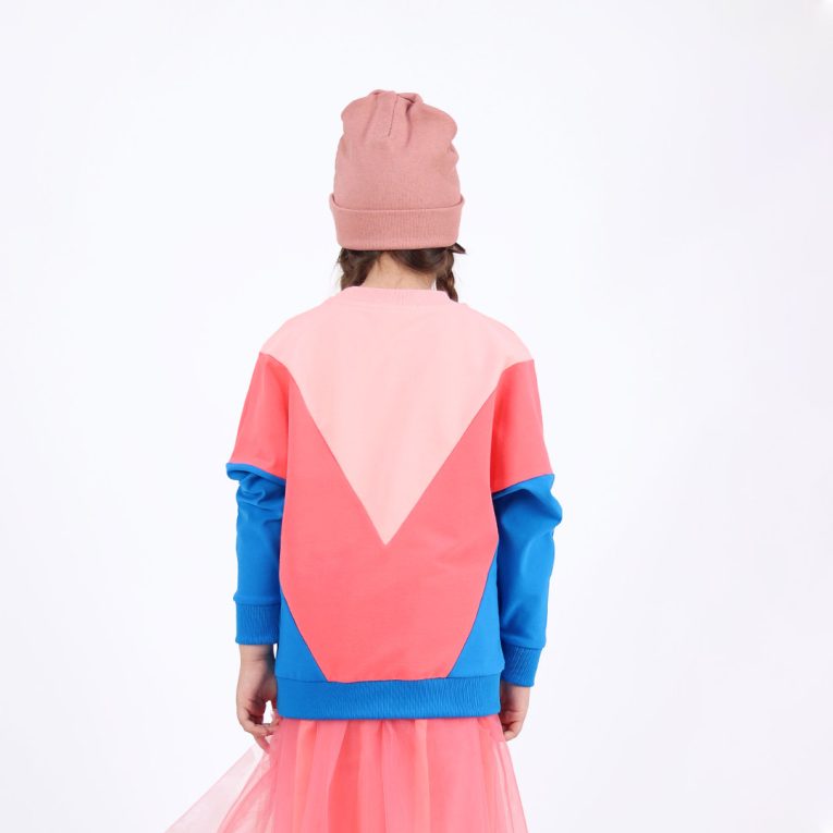 Batwing sweatshirt is a loose fit top with triangular form color blocks. It comes in a combo of three colours - powder, salmon and deep blue. Back view. Children, 3 -10 yrs. BonnyJoy