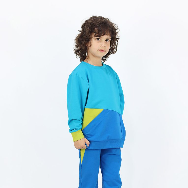 Big pocket sweatshirt is a regular fit top with an asymmetrical big pocket in front. A colour block design that comes in a combo of three colours - electric blue, deep blue, bright lime. Side view, a boy dressed. Children, 3 -10 yrs. BonnyJoy