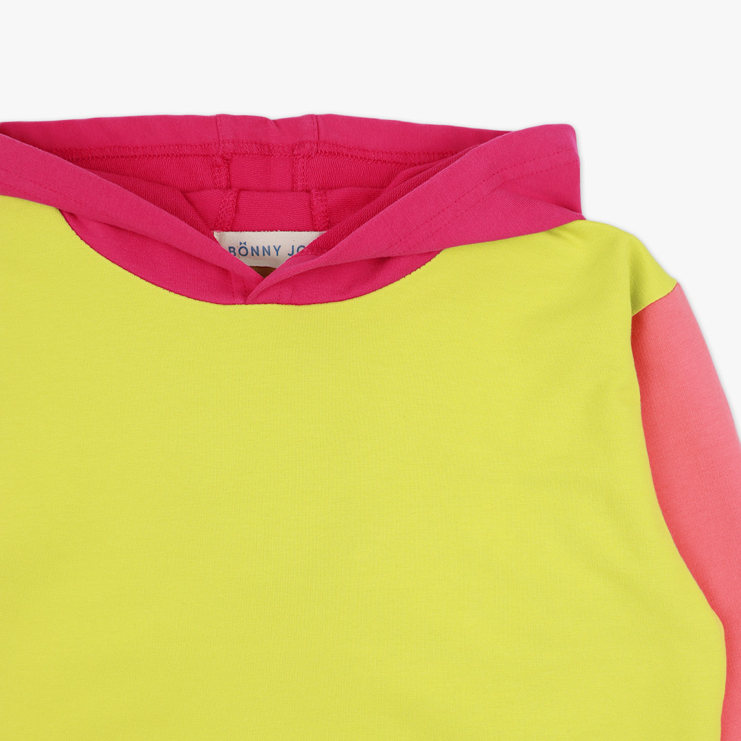 Colour Block Sweatshirt is a regular fit hooded sweatshirt with a kangaroo pocket in front. Front and back and right sleeve in bright lime colour. The hood and the hand cuffs - raspberry. The pocket and the left sleeve - salmon. close up view. Children, 3 -10 yrs. BonnyJoy