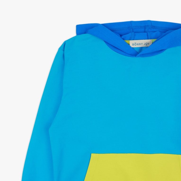 Colour Block Sweatshirt is a regular fit hooded sweatshirt with a kangaroo pocket in front. Front and back and right sleeve in electric blue colour. The hood and the hand cuffs - deep blue. The pocket and the left sleeve - bright lime. Close-up view. Children, 3 -10 yrs. BonnyJoy