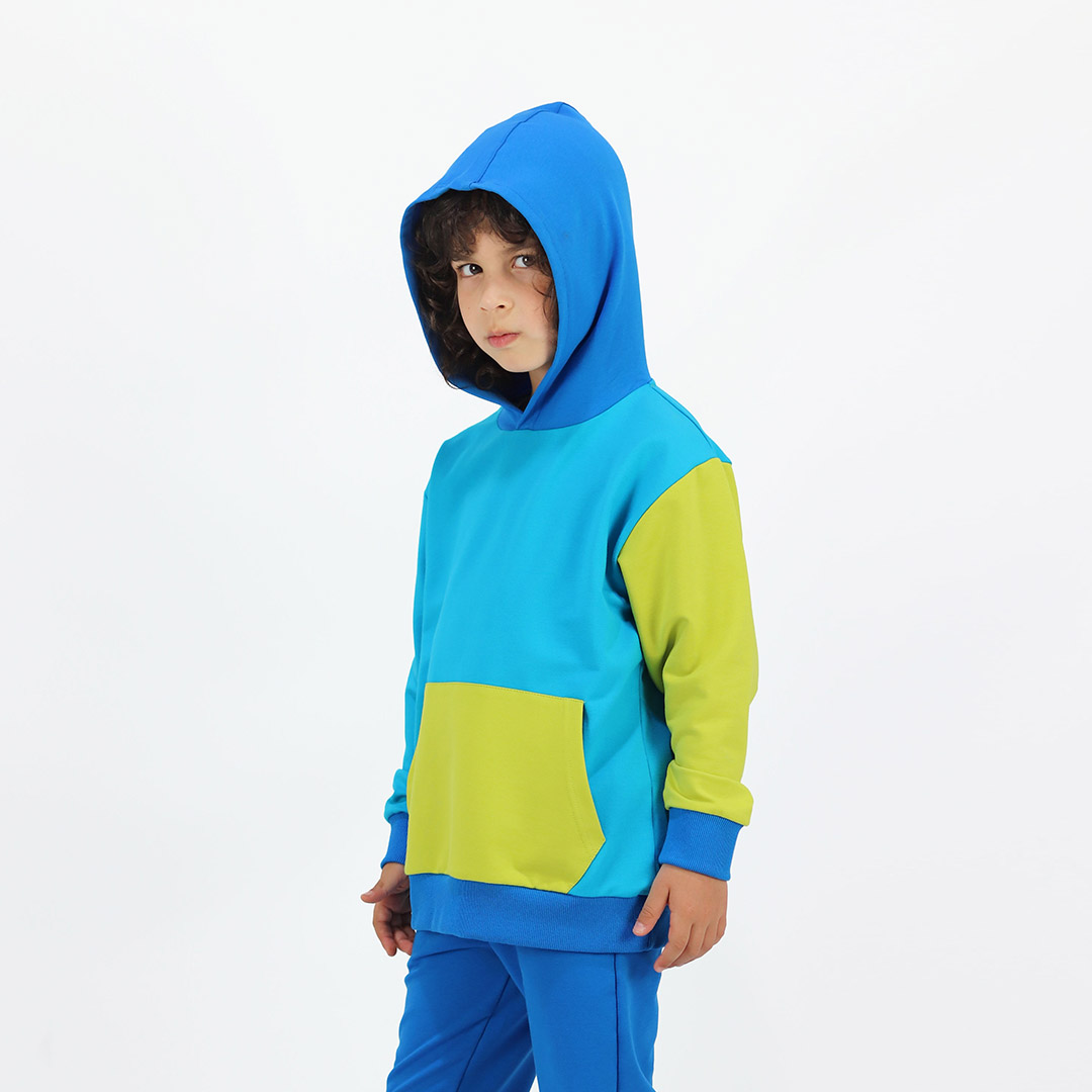 Colour Block Sweatshirt is a regular fit hooded sweatshirt with a kangaroo pocket in front. Front and back and right sleeve in electric blue colour. The hood and the hand cuffs - deep blue. The pocket and the left sleeve - bright lime. Front view, the hood on. Children, 3 -10 yrs. BonnyJoy