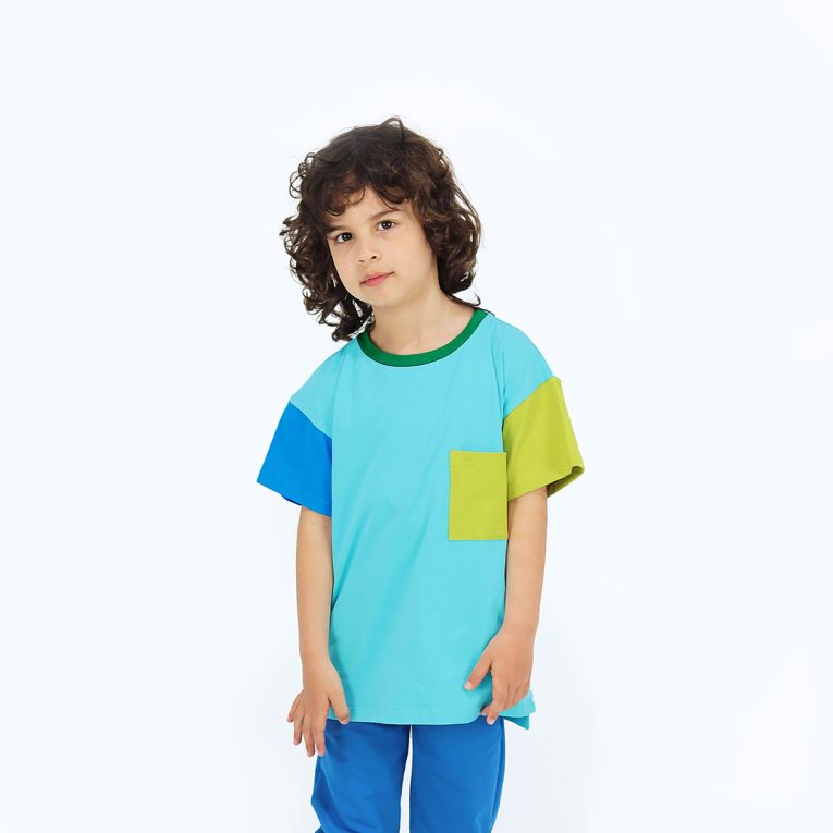 Our colour block t-shirt is a loose fit top with square pocket on the left and a little longer on the back. The front and the back in blue colour, right sleeve in electric blue, left sleeve and the pocket - in bright lime. On the neck - green colour. Children, 3 -10 yrs. BonnyJoy