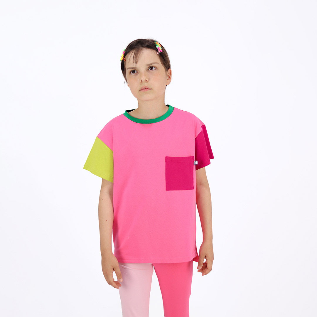 Our colour block t-shirt is a loose fit top with square pocket on the left and a little longer on the back. The front and the back in pink colour, right sleeve in bright lime, left sleeve and the pocket - in raspberry. On the neck - green colour. Children, 3 -10 yrs. BonnyJoy