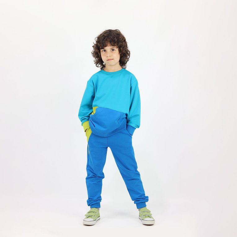Slim Fit Colour Block Joggers are a pair of sweatpants in deep blue with two Italian type side pockets in different colours - bright lime and salmon. It features ribbed waist and cuffs. Front view. Children, 3 -10 yrs. BonnyJoy