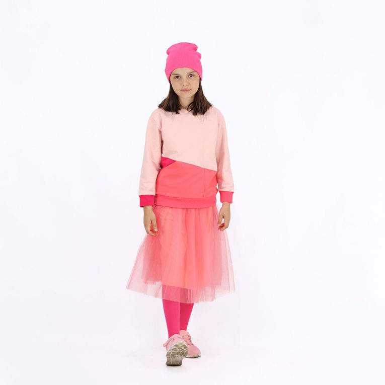 Our tulle skirt is a loose falling skirt made from tulle outside and jersey inside in salmon colour. Another front view.Children, 3 -10 yrs. BonnyJoy