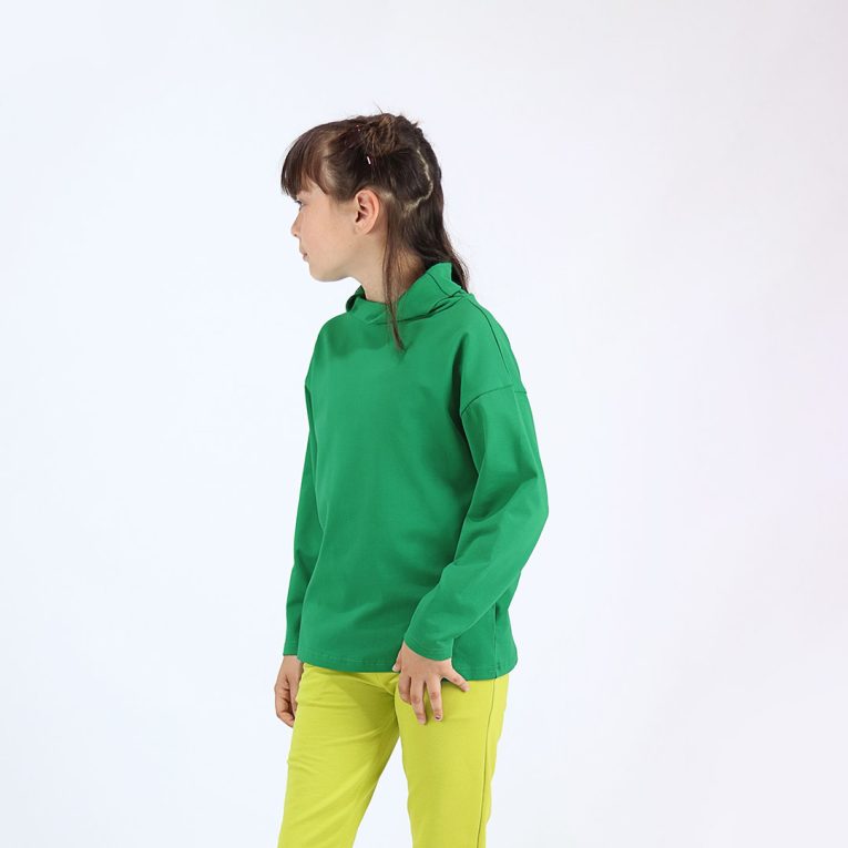 Turtleneck loose top is a classic top loose on the neck in green colour. Side view. Children, 3 -10 yrs. BonnyJoy
