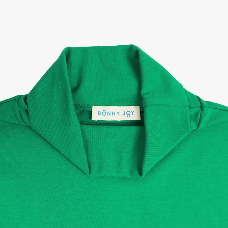 Turtleneck loose top is a classic top loose on the neck in green colour. Front view, close-up. Children, 3 -10 yrs. BonnyJoy