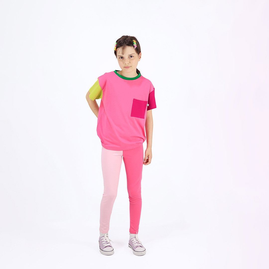 Two-colour leggings with two different colour legs. Left leg is light pink, right leg is pink and light pink weist. Front view, a girl standingChildren, 3 -10 yrs. BonnyJoy