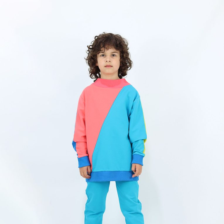Two-Way Sweatshirt you could wear back on front and the way round. Mix of colours on both sides and diagonal cut on the front and the back. On one side - one sleeve and one diagonal half - salmon, the other sleeve and the other diagonal half - electric blue. On the other side - one sleeve and half - bright lime and the other sleeve and other half - deep blue. Children, 3 -10 yrs. BonnyJoy