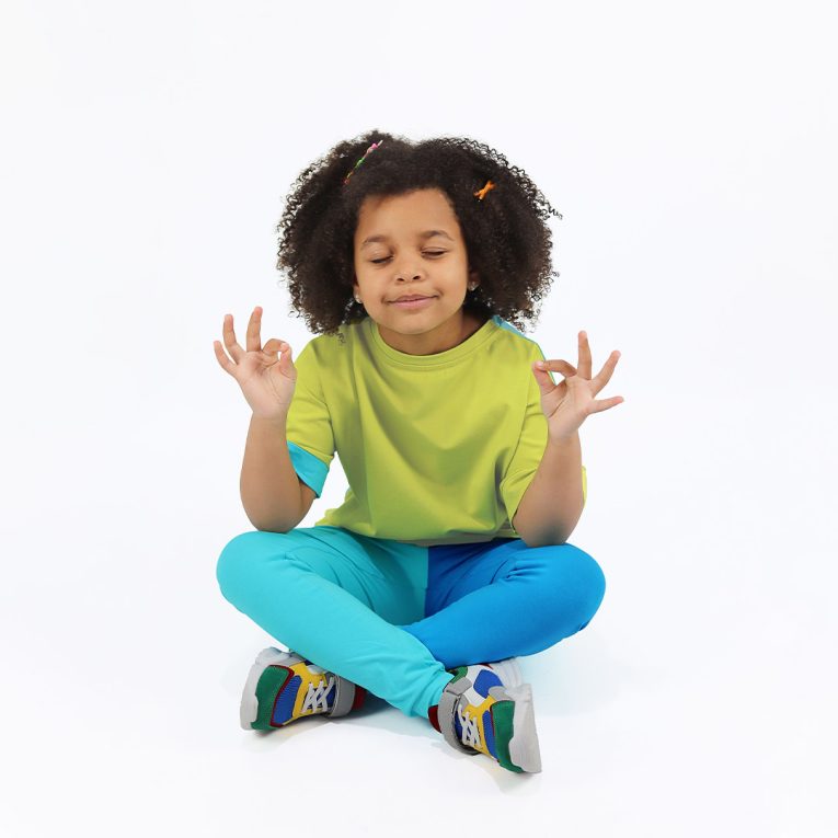 Our two-way top is a loose fit top with short sleeves in two colours. On one side is bright lime, on the other - blue colour. You could wear it front on the back and the other way round. Bright lime in front, a girl sitting. Children, 3 -10 yrs. BonnyJoy