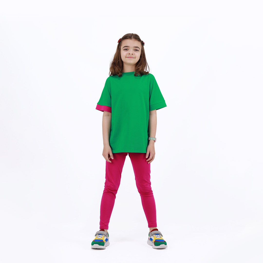 Our two-way top is a loose fit top with short sleeves in two colours. On one side is raspberry, on the other - green colour. You could wear it front on the back and the other way round. Green in front. Children, 3 -10 yrs. BonnyJoy